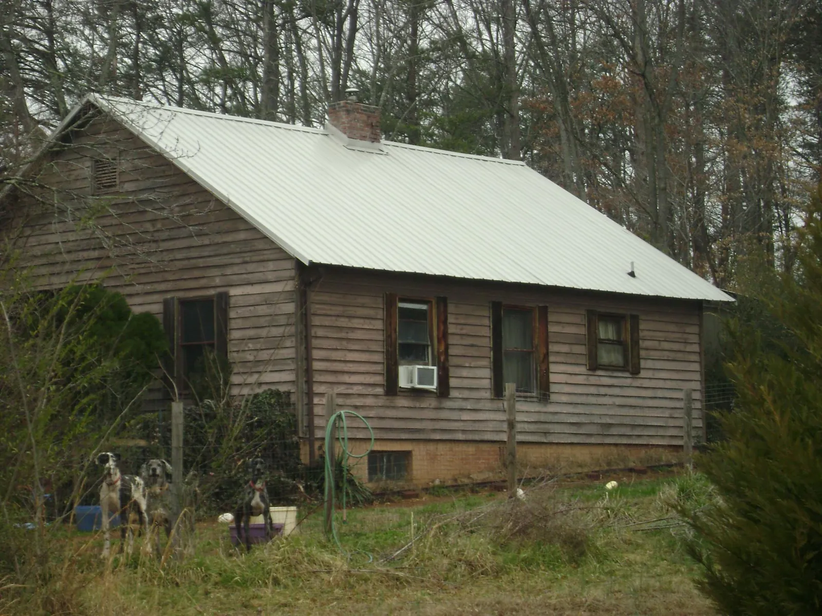 White metal roof on an old wood sided farmhouse, from a Metal Roof Installation job in Rock Cave